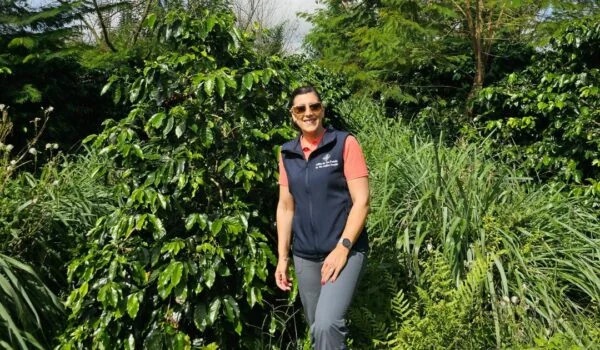 Woman standing in front of a coffee tree