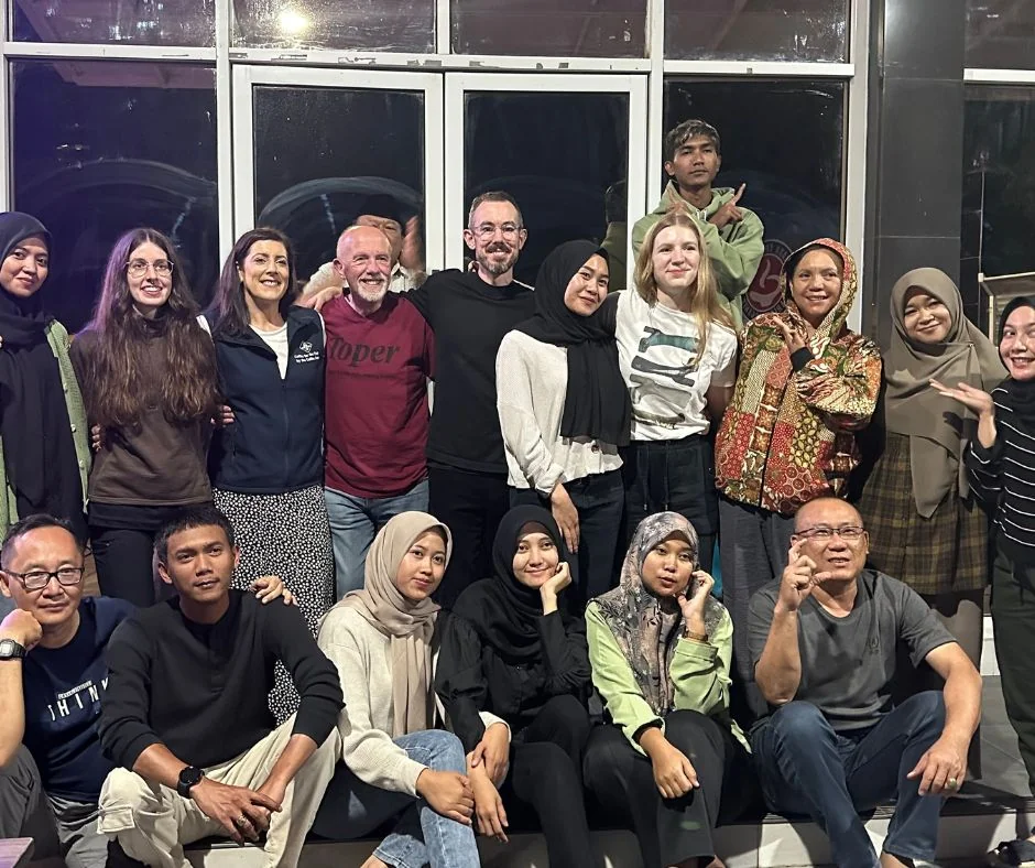group of people with arms around each other