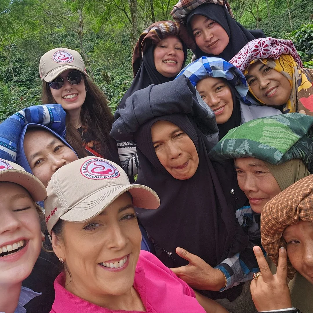 group of people crowded in front of camera and smiling
