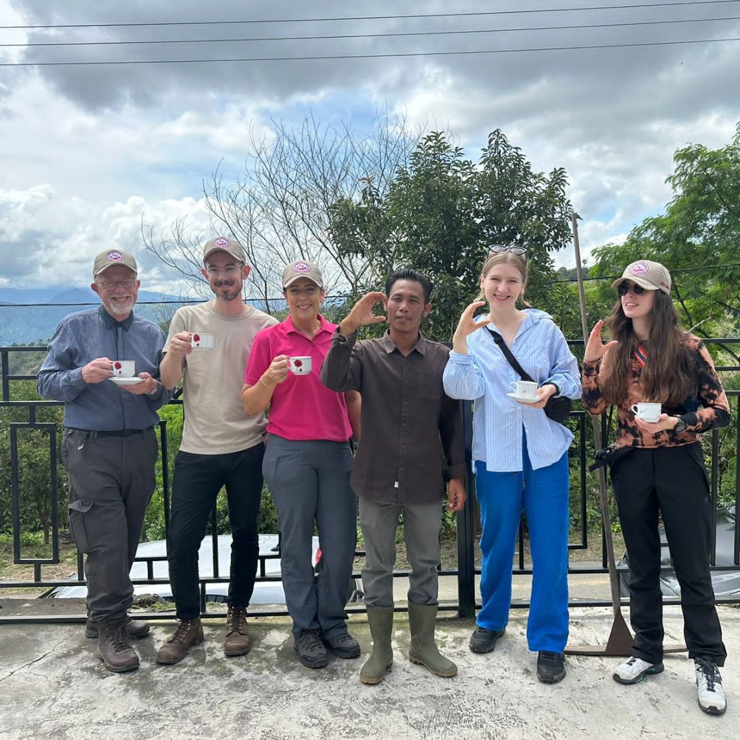 group of people outdoors holding cups of coffee