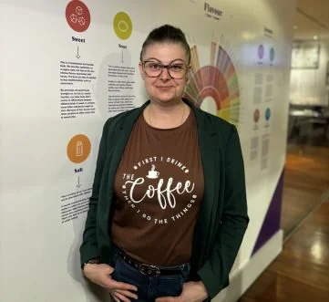 Picture of lady standing against a wall