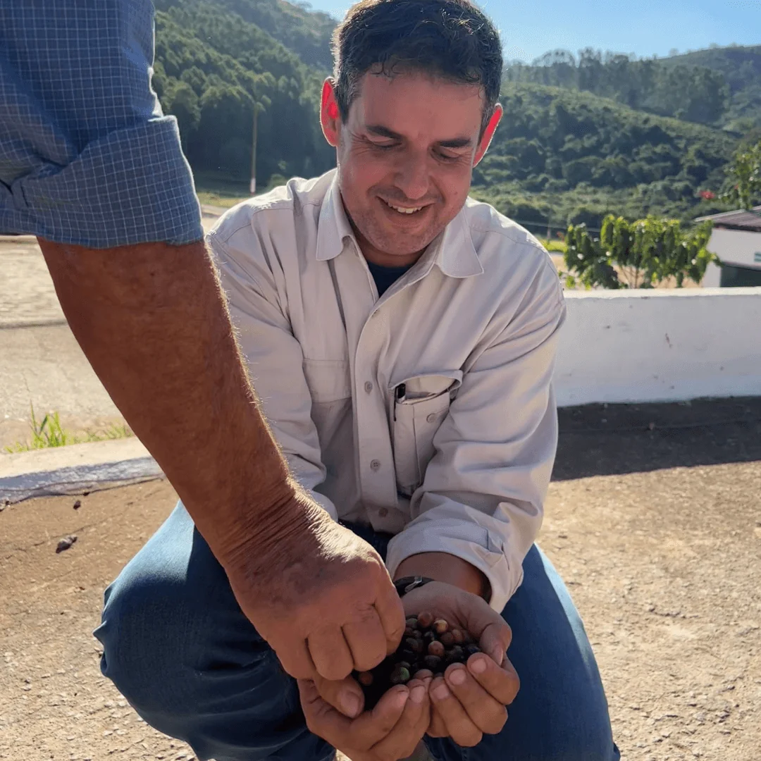 Father and son at Fazenda Palmittal - holding coffee cherries during our Brazil Origin Trip