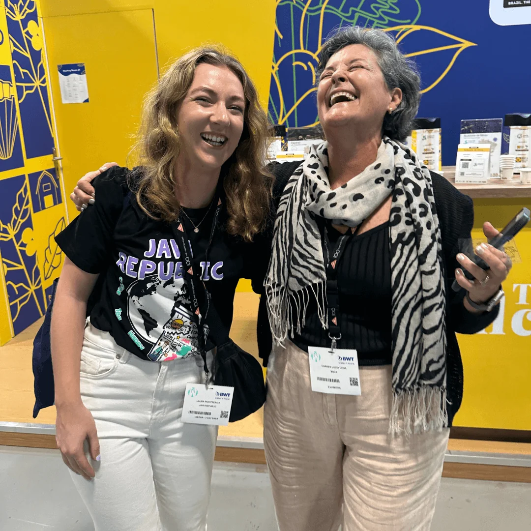Two coffee friends laughing