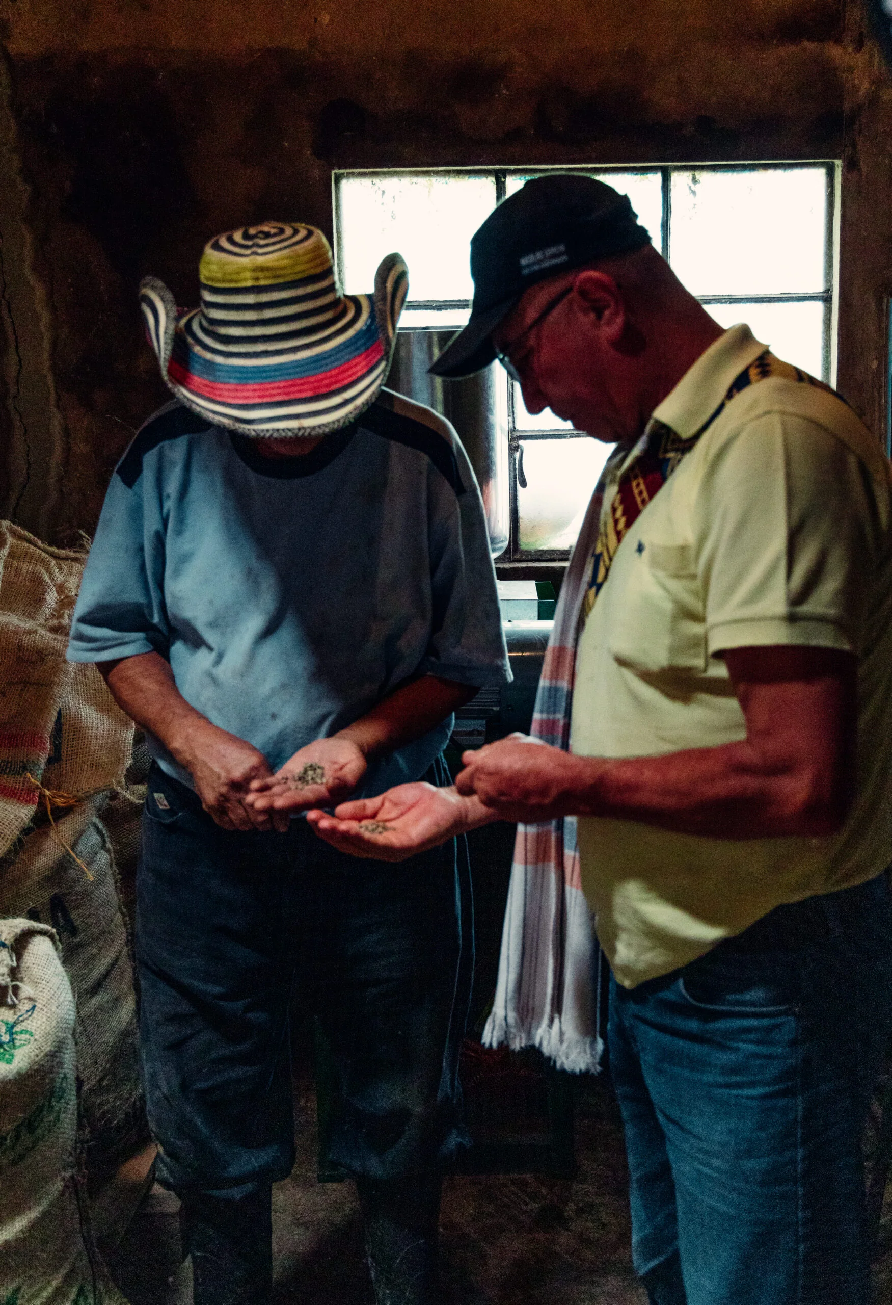 Two farmers from Colombia looking at their premium, ethically grown coffee beans